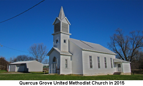 Color photo of a traditional white clapboard church with a tall steeple; caption reads: 'Quercus Grove United Methodist Church in 2015'